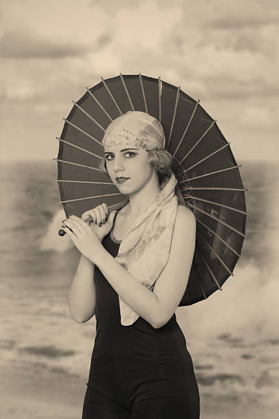 Flapper girl. Under umbrella Emulation of old postcard.Filters added for more effect. flapper hat stock pictures, royalty-free photos & images