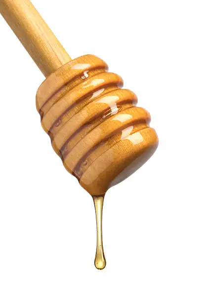 Wooden dipper with honey drop