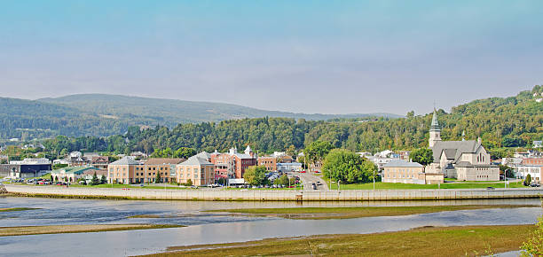 The Town of Malbaie , Quebec The town of Malbaie, Charlevoix, Quebec, Canada, showing the church, river delta, tide flats, and shoreline. charlevoix photos stock pictures, royalty-free photos & images