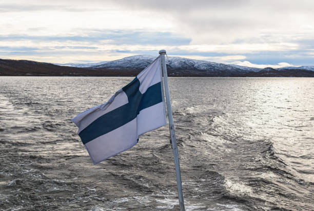 finland flag waving on the wind in the lake - saana imagens e fotografias de stock