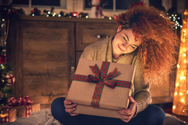 Happy young woman holding a Christmas presents stock photo