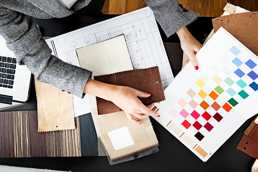 Woman picking out swatches from desk
