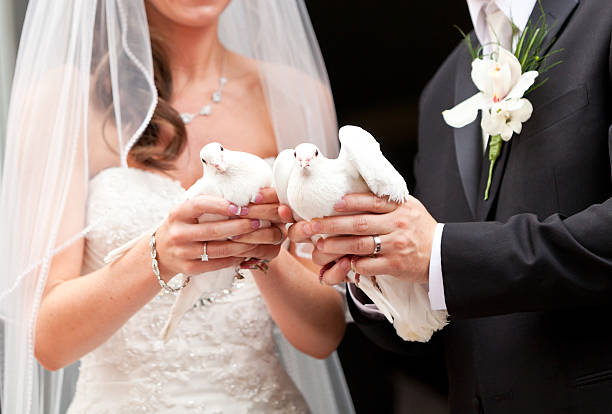 istock Newlyweds with white doves 171363755