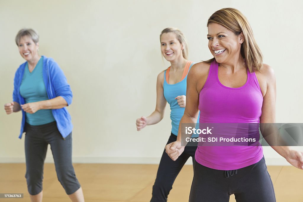 Women having fun together in fitness exercise class Women having fun together i fitness exercise class. Adult Stock Photo