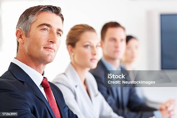 Attentive Business Executive Stock Photo - Download Image Now - CEO, In A Row, Business Meeting