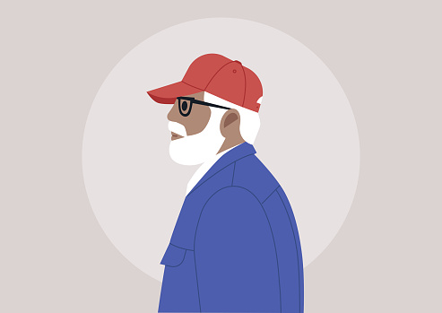 An elderly man with a white beard donning massive frame glasses and a red cap