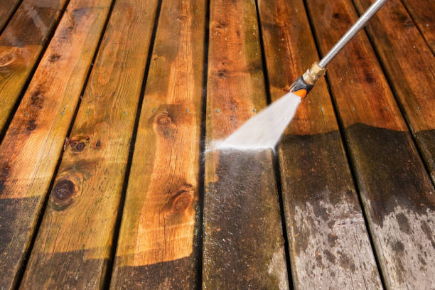 Pressure Washer Cleaning a Weathered Deck "A pressure washer sprayer is cleaning a weathered treated wood deck. The background area has been cleaned, the lower portion is dirty and weathered, showing the contrast." deck stock pictures, royalty-free photos & images