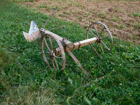 A Hand Steered and Horse Drawn Vintage Farm Plough. Ancient iron plow tool used in farming for cultivation of soil in preparation for sowing seed