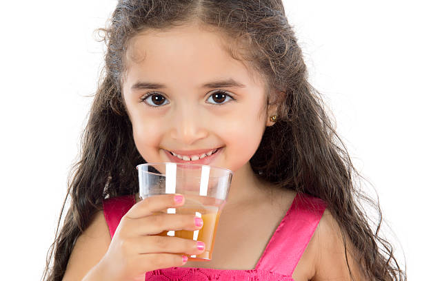 Healthy Lifestyle little girl is drinking juice vitamin b 3 stock pictures, royalty-free photos & images