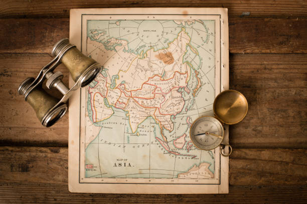 istock Antique 1870 Map of Asia, Binoculars, and Compass on Trunk 171365186