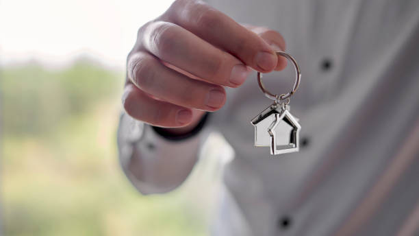 Selective focus on a keychain in the form of a house for a new home. stock photo