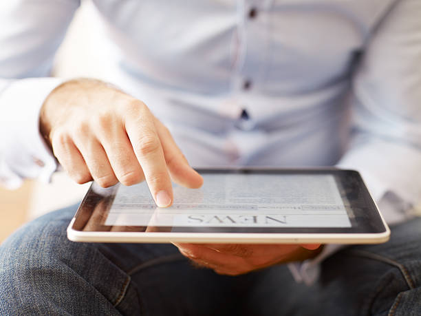 man reading news on the digital tablet