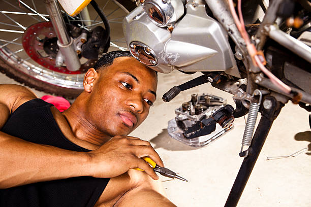 istock African descent man working on motorcycle repairs. 171365827