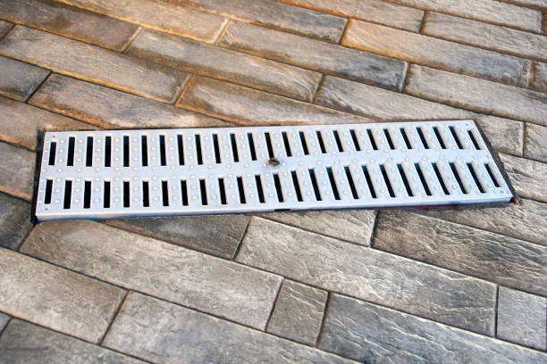 istock White plastic drainage grill for outdoor showers. Built into floor with rectangular tiles. Top view. Close-up. Selective focus. Copy space. 1713659381