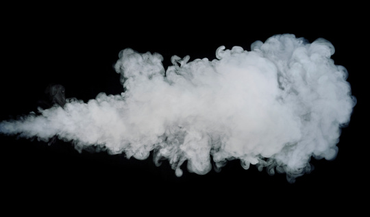 A jet of smoke or steam photographed against a black background.