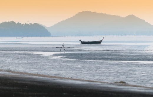 Long Tail boat sits in the beautiful beach in morning time .