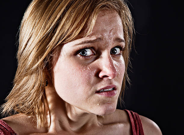 istock Sweat-covered young woman stares out looking absolutely terrified 171366357