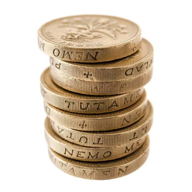 UK Currency: stack of one pound coins stock photo