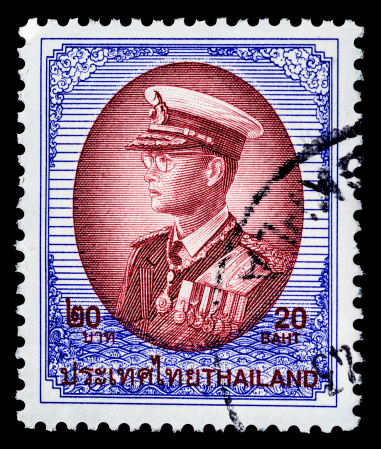 Military themed cancelled Thailand postage stamp isolated on black.