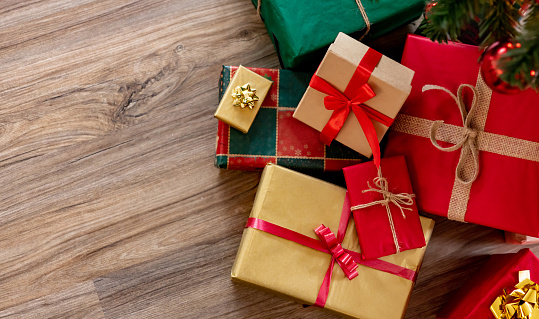 Beautiful wrapped Christmas presents under the tree - holiday season concepts