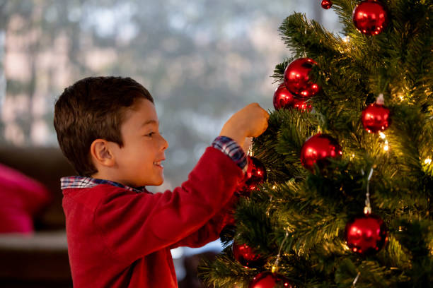 istock Happy boy decorating the Christmas tree 1713668634