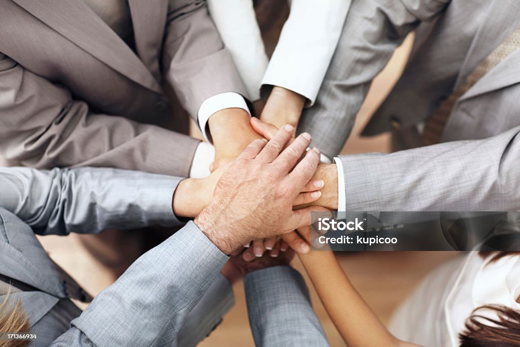 There's nothing we can't do together The hands of a group of employees showing unity Adult Stock Photo