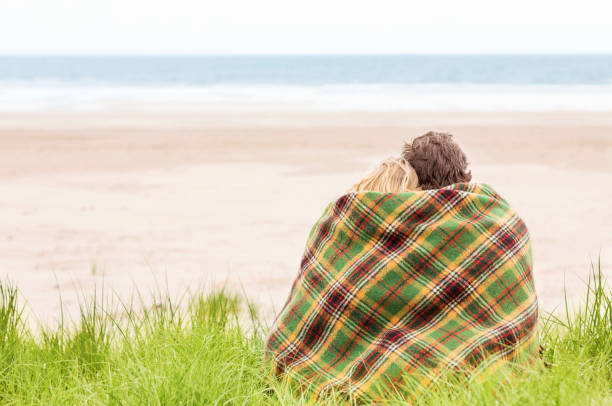 istock Couple Wrapped In Blanket At Beach 171366950