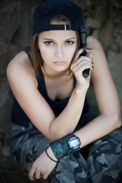 istock beautiful woman with gun 171366980