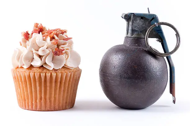 Fragment grenade Sitting next to a gourmet cupcake.