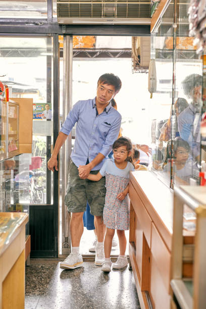 istock A father bring his daughter to an old style pharmacy. 1713671766