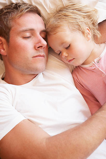 istock Father And Daughter Sleeping In Bed 171367615