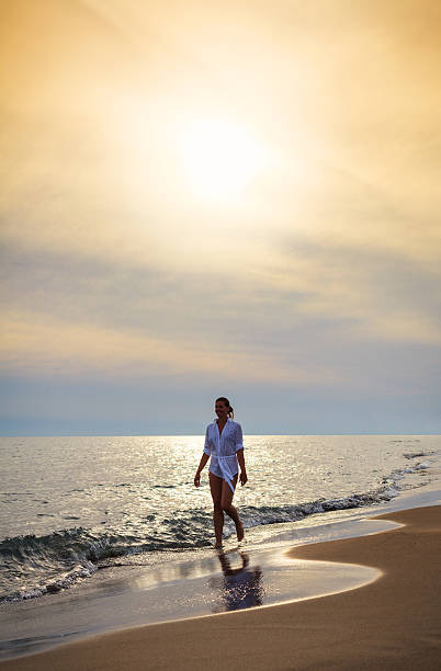 istock Young Woman Walks Along The Beach 171367890