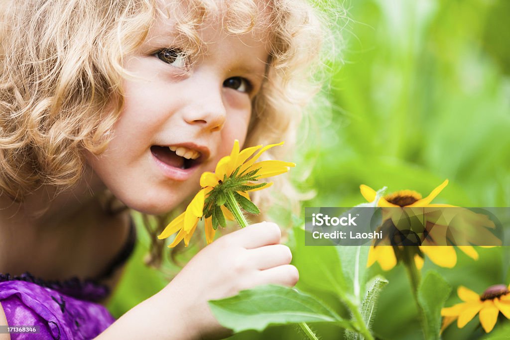 Girl with flowers Portrait of a smiling girl with flowers 2-3 Years Stock Photo