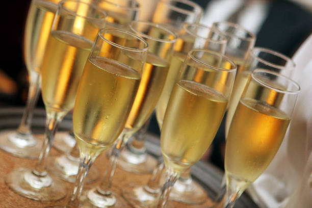 Close-up of unrecognizable wait staff serving champagne at a party