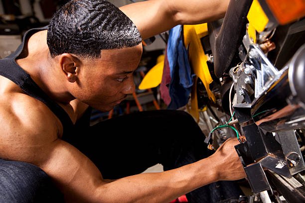 istock African descent man mechanic working on motorcycle. Repairs. 171368883