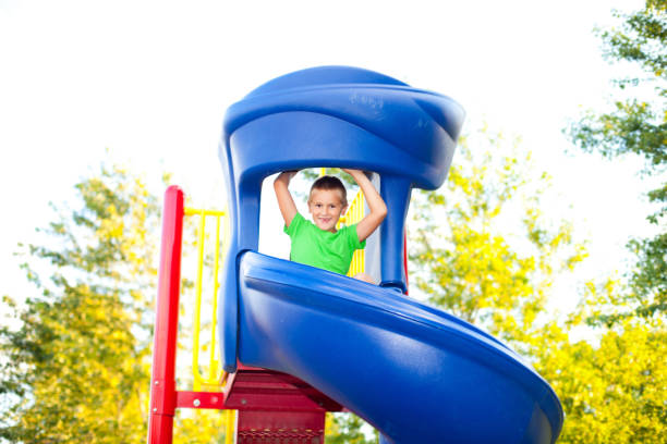 istock Boy sitting on slide at the playground 171369209