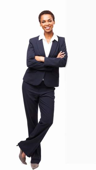 Full length portrait of a beautiful African American businesswoman standing with hands folded. Vertical shot. Isolated on white.