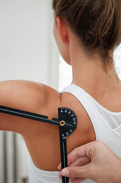 istock Physiotherapist measuring shoulder flexion with goniometer 171369403