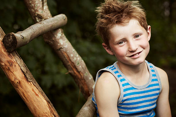 istock Boy sitting on a wooden ladder 171369519