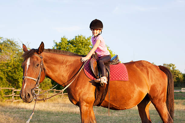 istock Child Riding Horse Outdoors. 171369609