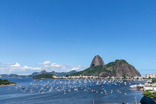 Panoramica of the beach and botafogo cove with its boats anchored and the sugar loaf hill in the background