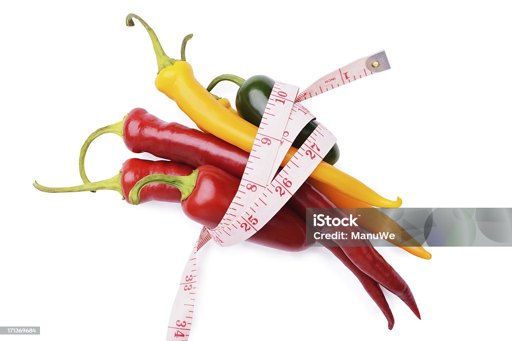 Chili peppers  and measuring tape on white Food and Drink Chili Pepper Stock Photo