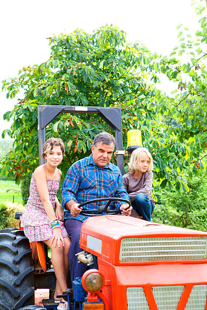 istock Grandfather and Children on a Traactor 171369865