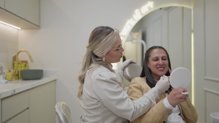 Dentist showing the procedure for patient at clinic