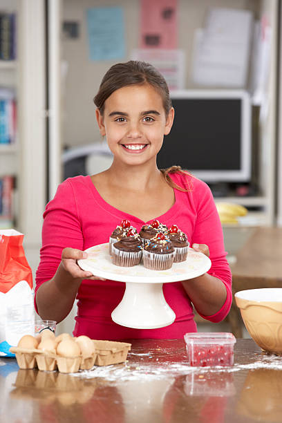 istock Girl With Homemade Cupcakes In Kitchen 171370431