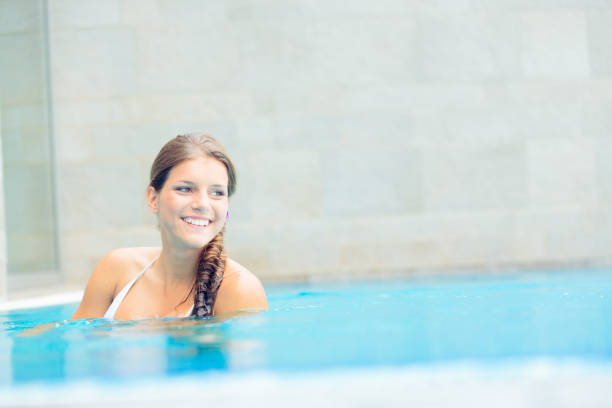 istock young woman relaxing in the pool 171370597