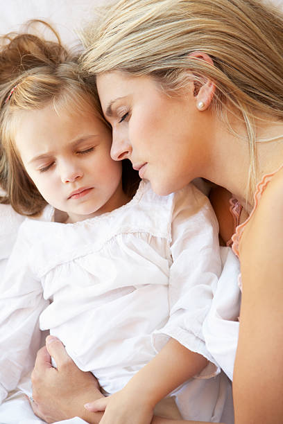 istock Mother And Daughter Sleeping In Bed 171370671