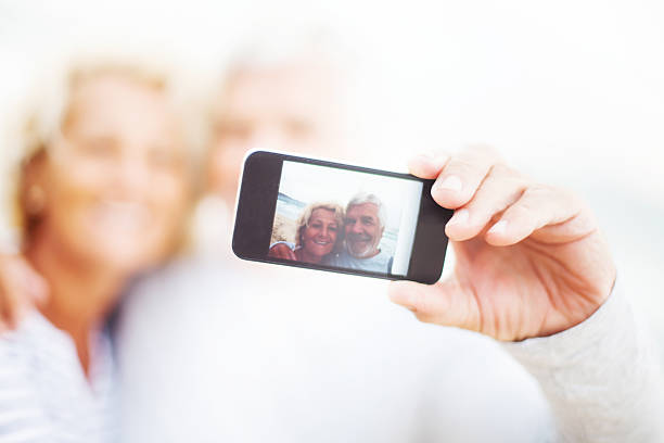 istock Smiling seniors taking photos 171370679