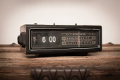 Older Digital Clock Radio Sitting on Wood Table