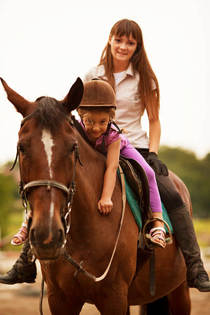 istock Child Riding Horse Outdoors. 171371192